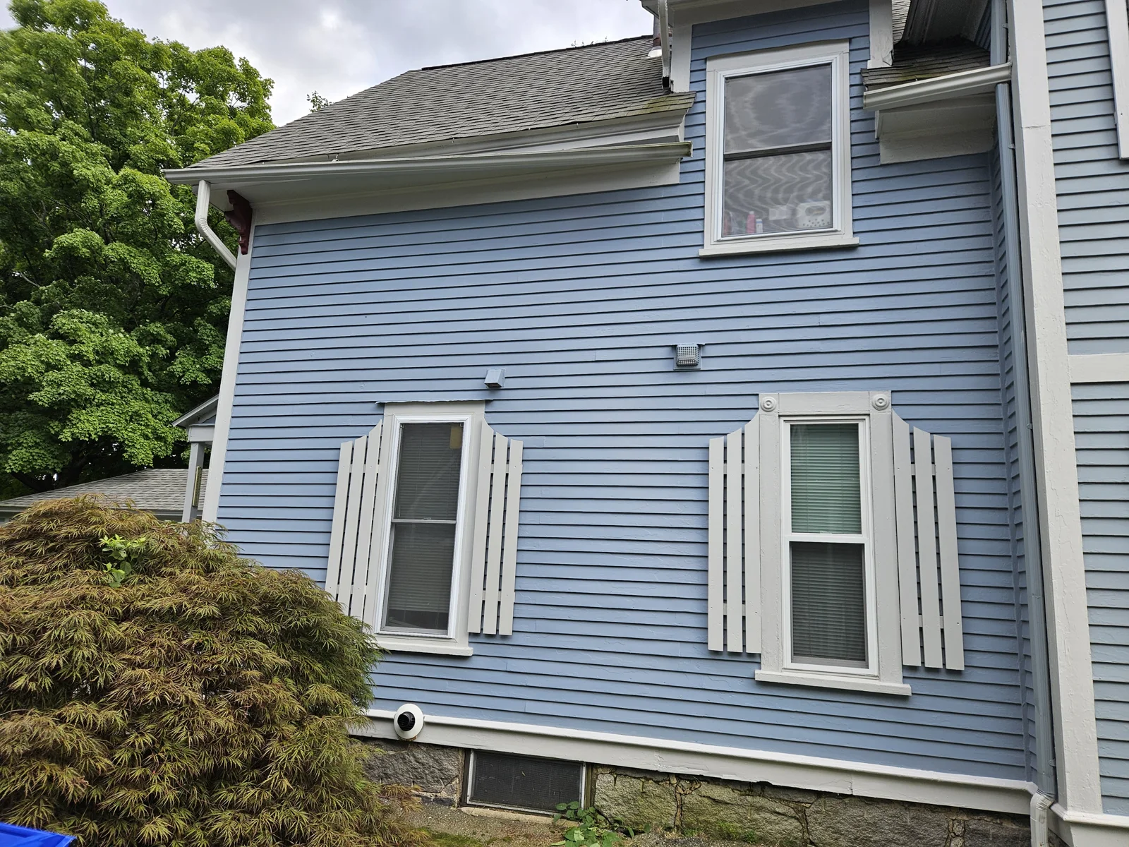 Completed exterior repaint—fresh soft blue paint with white trim after siding repair and professional restoration. T&B Paint Pros delivers expert exterior transformations. tbpaintpros Flagler County Florida experienced painter, specializing in high-quality, long-lasting home painting.